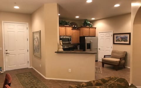 Entry hall and kitchen showing laundry room door