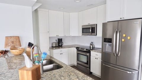 Fully equipped kitchen with granite counter tops and stainless steel appliances.