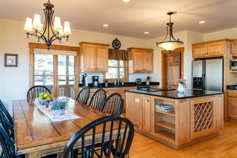 Large dining table with seating for ten and additional seating at the bar.