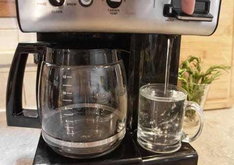 Drip coffee maker + hot water dispenser — coffee, tea, and hot choc. provided.