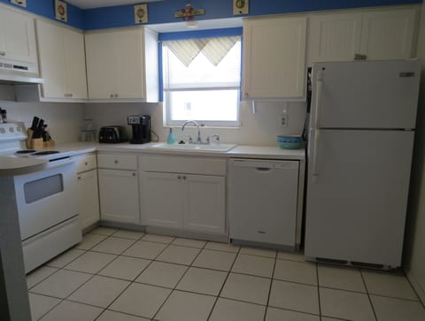 Fully stocked kitchen with all of the utensils, dishes, glasses, appliances...