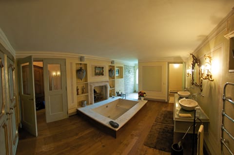 Master bathroom with fireplace by the tub