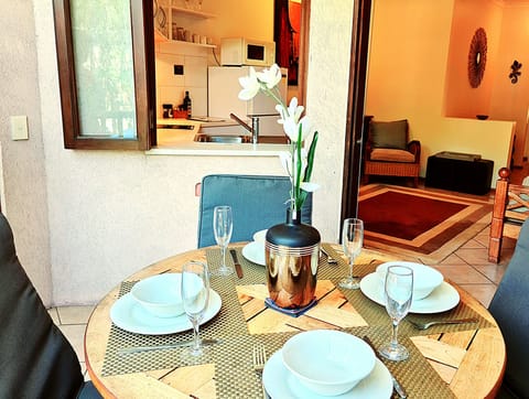 Outdoor dining on your private balcony overlooking the pool.
