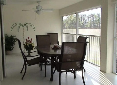 Oversized Lanai with granite tables and six chairs, two are rockers with ottoman