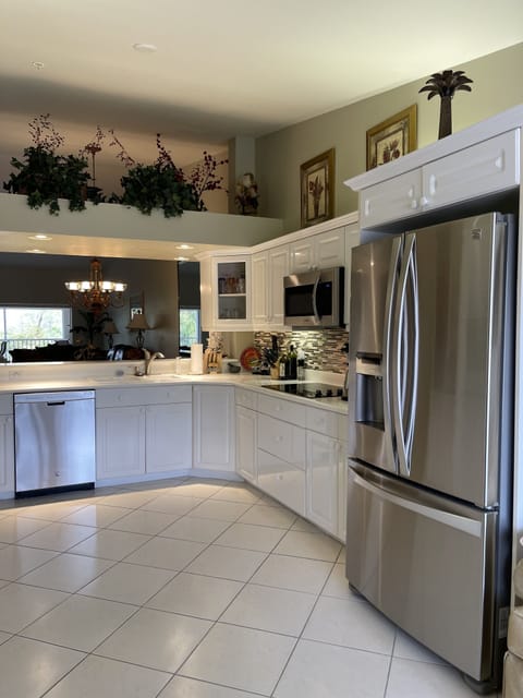 Kitchen features new refrigerator, dishwasher, and microwave.