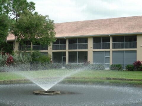 There is a lighted fountain and pond visible from the lanai, which on the left.