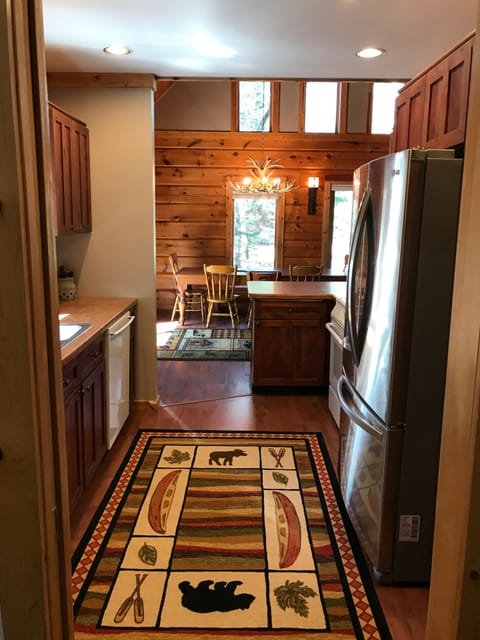 View of the kitchen looking toward the open concept Dining/Living and outdoors