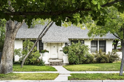 Bungalow style home with large trees