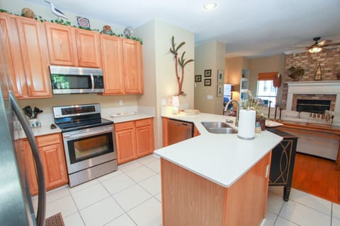 Kitchen has Quartz Counters and Ample Cabinets