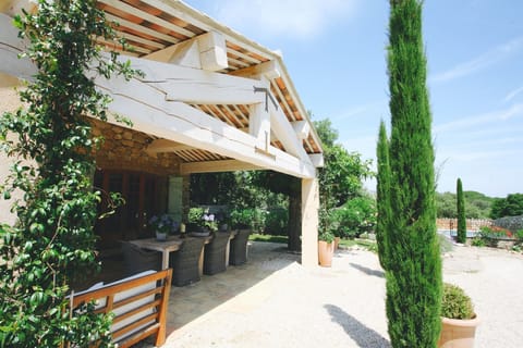 Bastide 1 covered terrace with comfortable sofas, dining area with armchairs