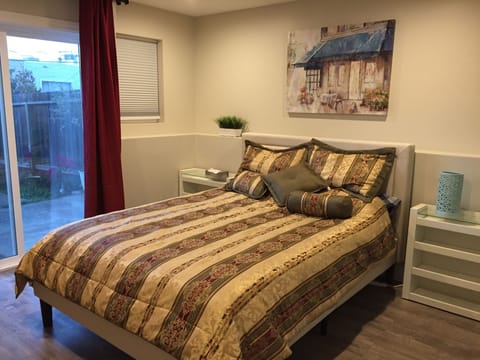 Bedroom with queen bed and access to garden