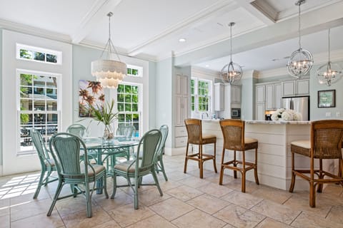Breakfast (6) and island seating (5) by the kitchen. View to pool deck spa area.