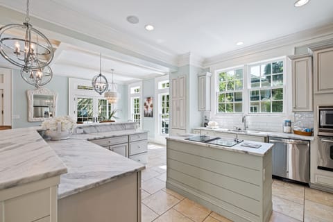 Newly remodeled kitchen with a view out the window to the pool deck spa area