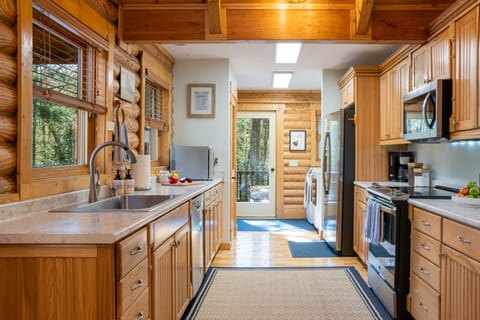 Kitchen and laundry area. Door in back leads hot tub, grill, and lounge area
