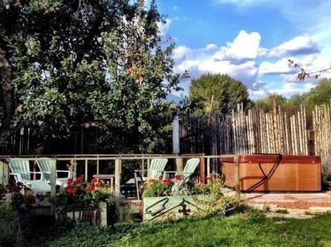 Hot tub and deck with outdoor fireplace under the old apple tree.