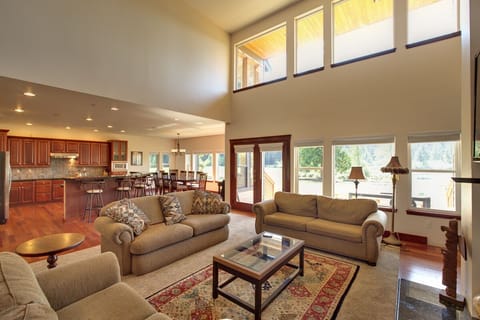 Lake view from living room and dining room with kitchen in the background.