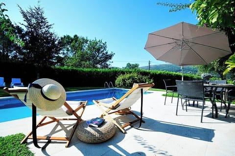 Alfresco dining overlooking swimming pool and garden