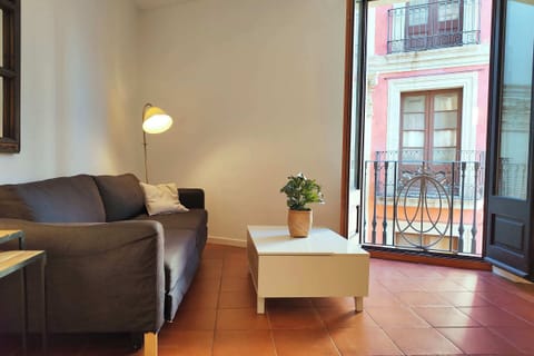 Comfortable living room with dual views of La Rambla and Carrer de Tallers — the city at your feet.