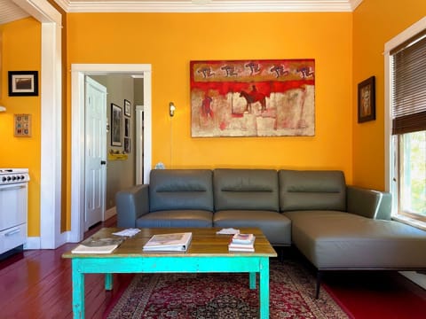 Living room with large leather couch to relax on & watch birds out the window.