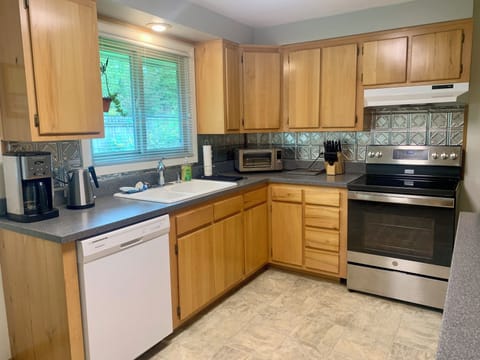 Spacious kitchen with cultured marble countertops and pressed tin backsplash.
