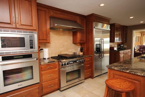 Gourmet Kitchen: double ovens, microwave, 6 burner stove top, one of 3 fridges.