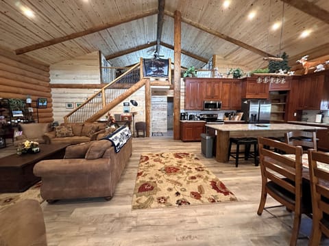 Wide view of living room, dining area, kitchen, and loft area.