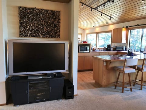 TV/DVD/Stereo with Bose sound system in the Living Room.  Kitchen next to it.