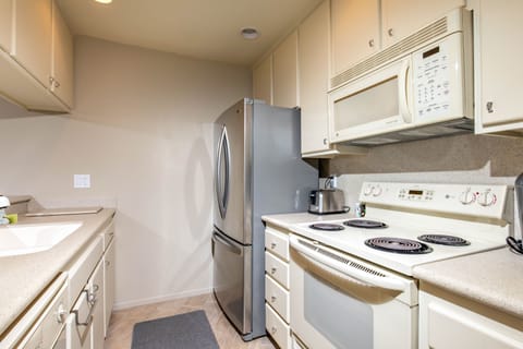 The kitchen is equipped with dishes, pots and pans, and cooking utensils.
