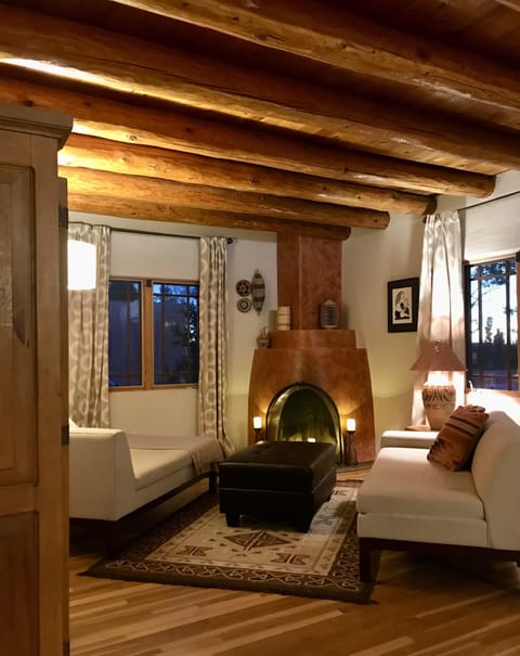 Livingroom with Kiva fireplace, vigas and wood floors