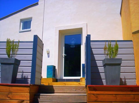 The entrance in the small east terrace