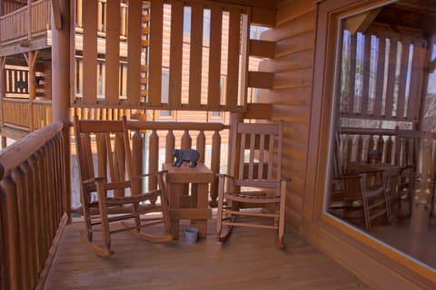 Lower deck equipped rocking chairs and picnic table.
