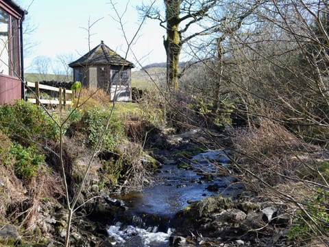 In addition to the summerhouse the cottage has a bridge over the adjacent stream min the garden | Arkland Mill - Crofts Cottages, Near Castle Douglas