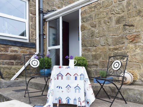 Small sitting-out area with garden furniture | Sea Breeze Cottage, Cowbar, near Staithes
