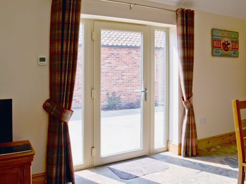 French doors opening on to the courtyard area | The Parlour - Dunstall Lodge Barns, Sutton-on-Trent