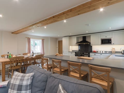 Open plan living space with exposed brickwork and a well-equipped kitchen and dining area | White Lodge Cottage, Carlton Miniott, near Thirsk