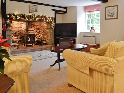 Living room with inglenook fireplace and wood burning stove | Karslake House, Winsford, near Dulverton