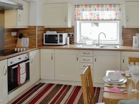 The farmhouse kitchen style dining table in the kitchen/dining area | Barnhill Bothy, Moffat