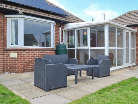 Paved patio area with furniture | Sea La Vie, Mundesley, near North Walsham