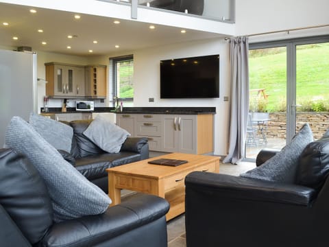 Relaxing open plan living space with wood burner and 65&rdquo; Freeview TV | Heartwell Cottage - Bowlees Holiday Cottages, Wolsingham, near Stanhope