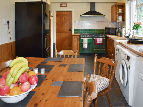 Convenient dining area within well-equipped kitchen | Oakdene Lodge, Wimborne