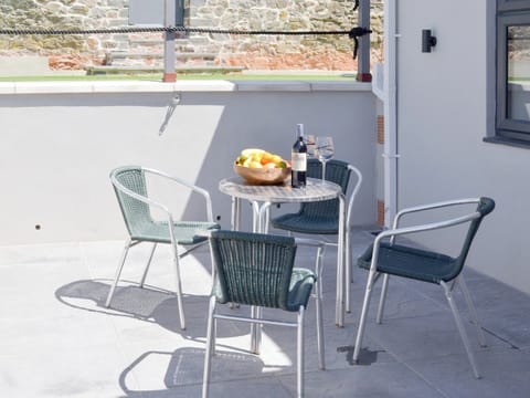 Patio area with outdoor furniture | Deepwater Point Apartment, Torquay