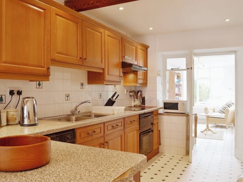 The tiled kitchen gives way to the sun room | The Old Post Office, Myddfai, near Llandovery