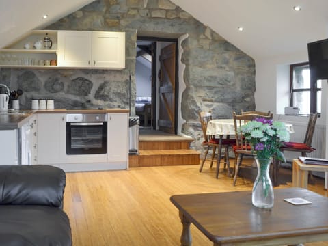 Open-plan room incorporates living, dining and kitchen areas | The Stables - Tyddyn Iolyn, near Criccieth