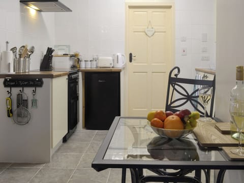 Convenient open-plan kitchen | The Snug - Ty Copr, Pen-y-Sarn, near Amlwch