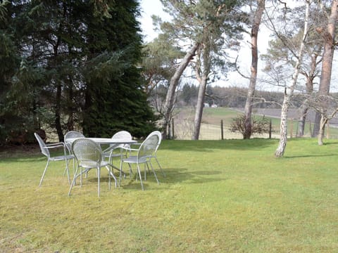Lawned area of garden with outdoor furniture | The Barn, Kildary, near Tain