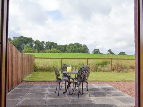 Double doors from kitchen leading to rear patio and garden | The Ploughmans - Loch Lomond Farm Cottages, Balfron Station, near Stirling