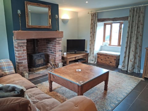 Cosy living room with wood burner | Swallow Barn, Torpenhow, near Wigton