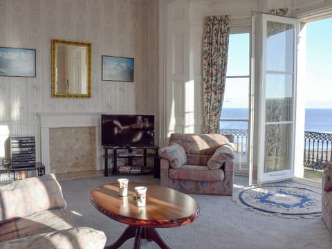 Comfortable living room with doors leading onto the balcony | Frank&rsquo;s View, Saltburn-by-the-Sea
