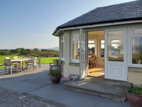 Paved patio with access from the conservatory | Degnish Farmhouse, Kilmelford, near Oban