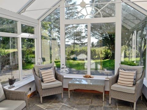 Relax in the sunny conservatory which overlooks the garden | Horsepark Cottage, Gatehouse of Fleet